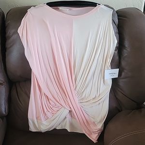 Beautiful top new with tags. It has a twist front. Come slightly off shoulder.